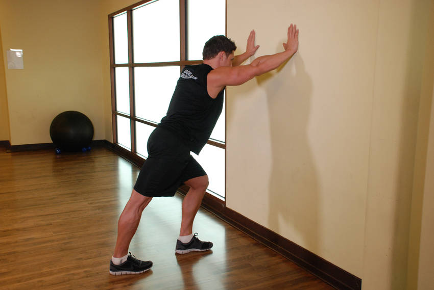 Calf Stretch Hands Against Wall — starting position