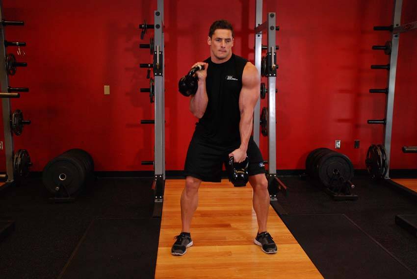 Double Kettlebell Alternating Hang Clean — end position