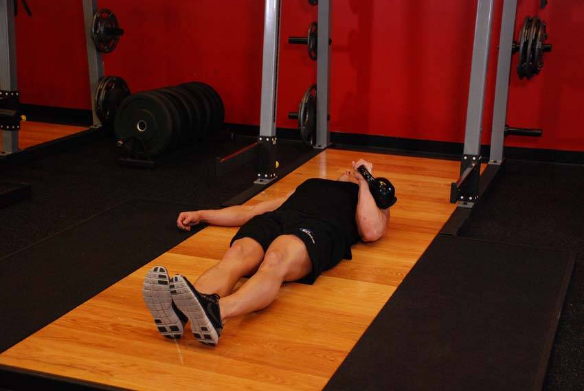 One-Arm Kettlebell Floor Press — starting position