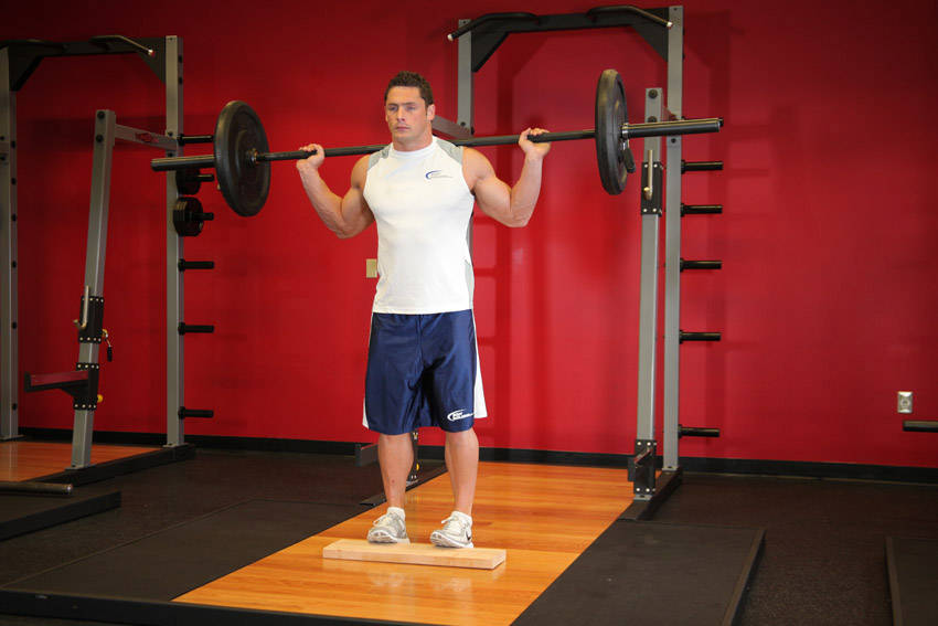 Standing Barbell Calf Raise — end position